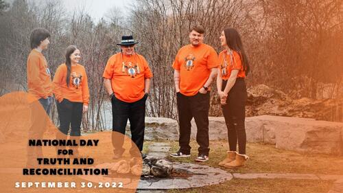 Five people wear orange truth and reconciliation t-shirts.