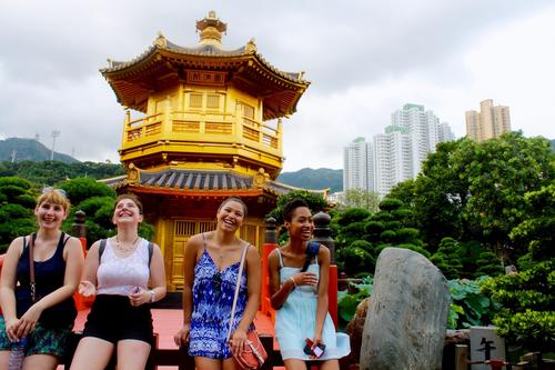 Students stand in front of a yellow temple at the Chi Lin Nunnery in Hong Kong.