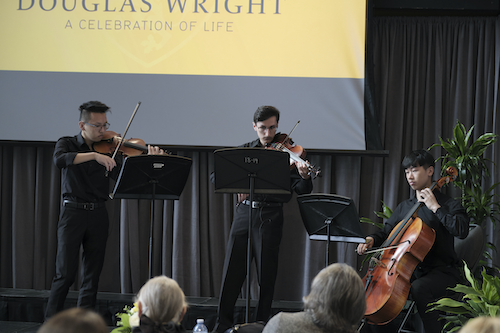 A strings trio featuring students Frank Wang, Shayan Saebnoori and Robert Cho perform on stage.