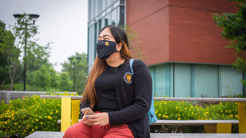 A student wears a mask on campus.