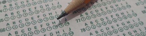 A pencil sits atop a page from a multiple choice exam paper.