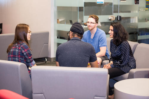 Students chatting in a residence lounge.