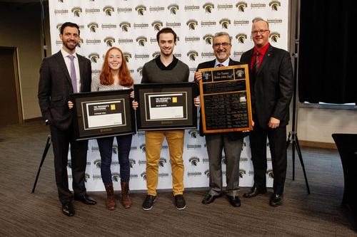President Hamdullahpur stands with Athletics representatives and the top academic student-athlete award winners.