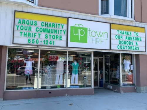 An exterior shot of the Uptown Thrift store with a marquee thanking Argus