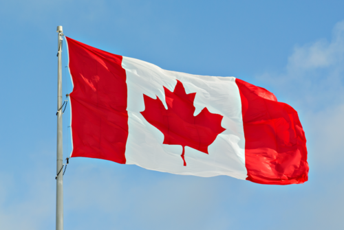 The Canadian national flag on a flagpole.