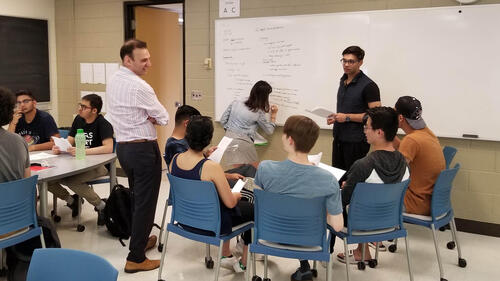 A professor and students in an engaged learning setting.