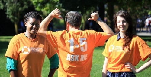 Three people wearing orange Mental Health t-shirts