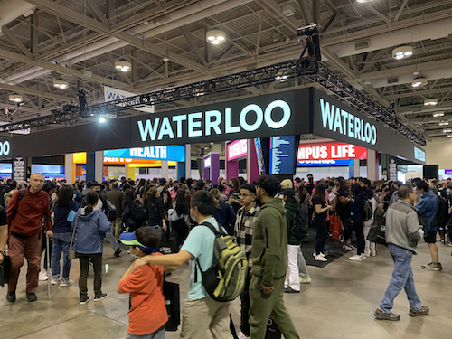 The University of Waterloo's booth at the OUF fair, surrounded by crowds.