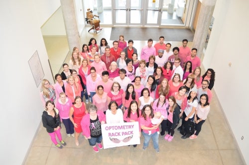 The members of the Optometry Rack Pack in their pink shirts.