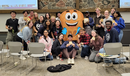 The Toasty mascot with a group of United College students and staff.