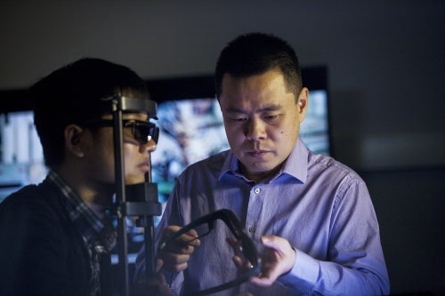 Professor Zhou Wang works with a lab assistant.