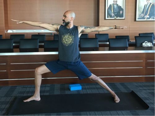 A man does a yoga pose.