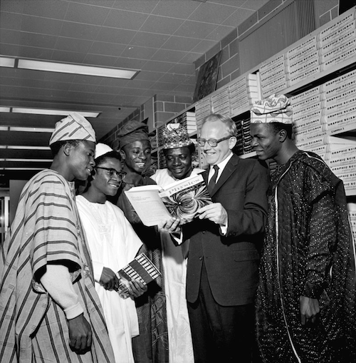 Dean of Engineering Douglas Wright shows off the bookstore's contents to five international students from Nigeria in 1962.