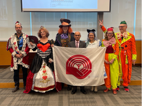 The six Deans in costume, the United Way flag, and President Vivek Goel in the Senate chamber.