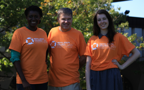 Volunteers sport their orange Mental Health Wellness Day t-shirts.