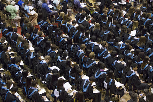 Students sitting in Convocation robes.