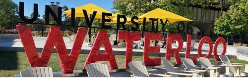 The University of Waterloo sign with the &quot;Waterloo&quot; portion wrapped in red for the United Way.