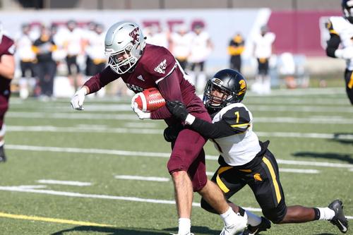 A Waterloo Warrior tackles a player from the Ottawa Gee-Gees. Photo by Greg Mason.