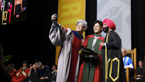 A PhD graduate takes a selfie with his supervisor and new Chancellor Jagdeep Singh Bachher.