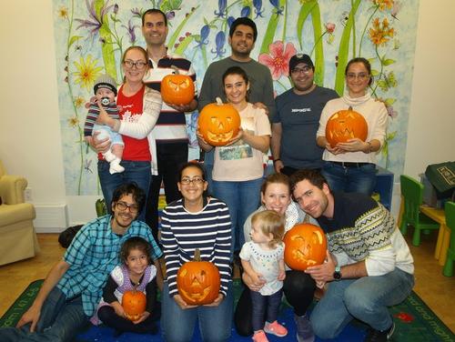International Spouses group members show off their pumpkin-carving skills.