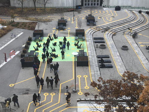 An overhead view of the redesigned arts quad, featuring the green of a circuit board and yellow circuit lines.