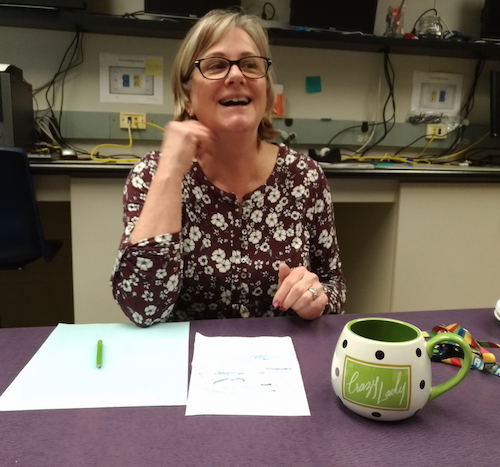 Mary Burden sits with a mug emblazoned with the phrase &quot;crazy lady.&quot;