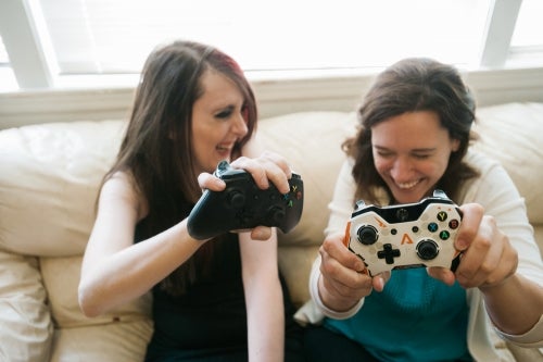 Brianna Wu and Alexandra Orlando hold up Xbox controllers.