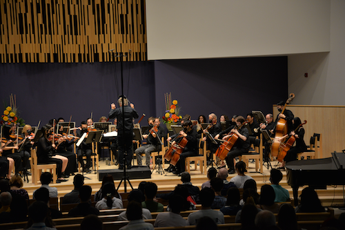 The University orchestra performing on stage.