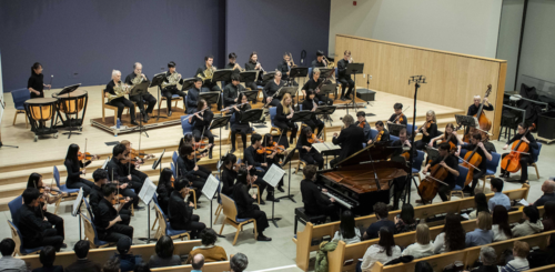 The Orchestra@UWaterloo performs on stage.