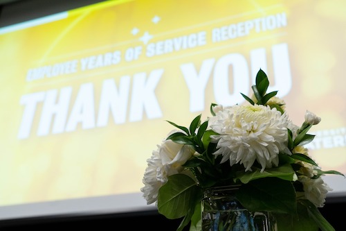 A screen projection that says &quot;thank you&quot; next to a bouquet of flowers.