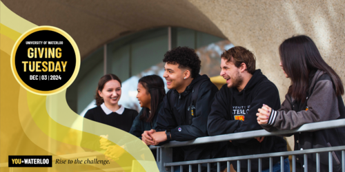 University of Waterloo students wearing branded clothing stand together smiling.