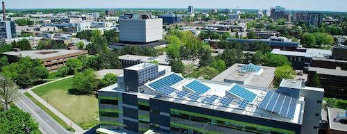 An aerial view of campus showing the solar panels on the EV3 building.