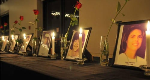 Photos of the 14 women killed on December 6, 1989 with candles and roses.
