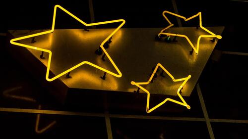 Yellow neon lights in the shape of stars.