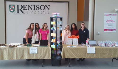 Members of Renison's School of Social Work stand with the feminine hygiene products collected for women staying in emergency shelters.