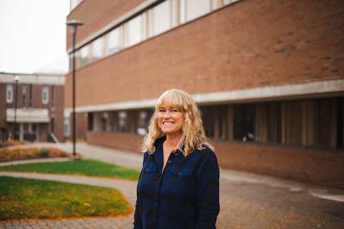 Maureen Stafford stands in front of Hagey Hall.