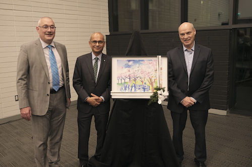 Vice-President, Academic &amp; Provost Jim Rush, President Vivek Goel, and Dennis Huber stand with an artist's conception of the Huber Lane project.