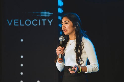 A young woman speaks at the Velocity Fund Finals event
