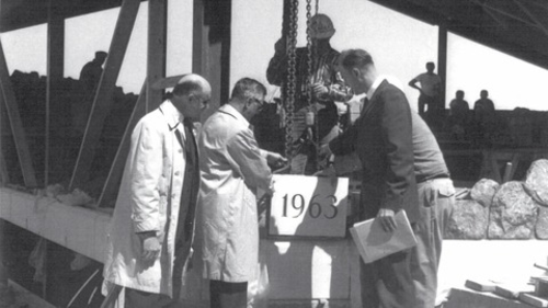 The Conrad Grebel cornerstone (reading 1963) is laid at the construction ceremony in 1964.
