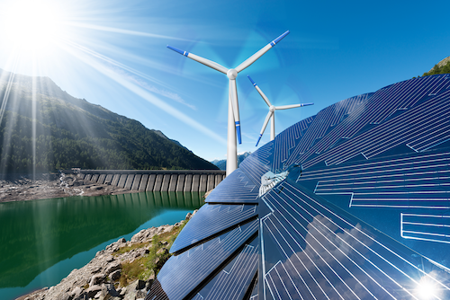 An image of sustainable energy sources - hydro dam, wind turbine, and solar panels.
