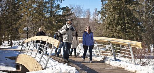 students walking over a bridge