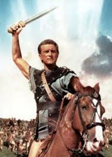 Kirk Douglas holds a sword aloft in a pose from the movie "Spartacus."