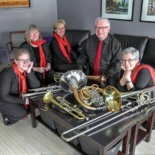 Members of the Full House Brass pose with instruments.