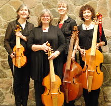 Members of the Cardinal Consort of Viols stand with their instruments.