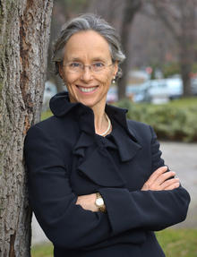 Portrait photo of Dianne Sax leaning against a tree