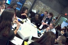 Participants at the Design Jam sit around a table.