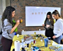 Volunteers decorate pots as part of the Earth Hour festivities.