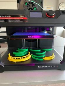 A 3D printer puts out face shields.