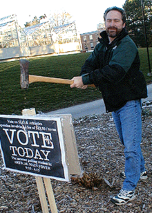 Dave McDougall hammers a Vote.Feds.ca election promotion sign into the ground on campus.
