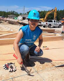 Gongyi Zhang, a mechanical engineering student who graduated last year, works on a home at the Habitat for Humanity project site.